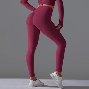 Macro back view of berry red high-waisted yoga pants showing lifting peach buttock effect