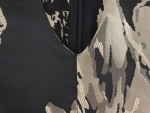 Close-up of elegant V-neckline with jacquard floral texture and invisible back zipper