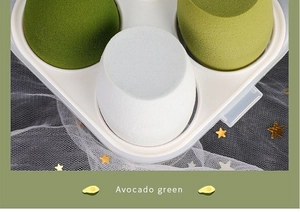 Detail of avocado green beauty blender set in a white plastic storage container