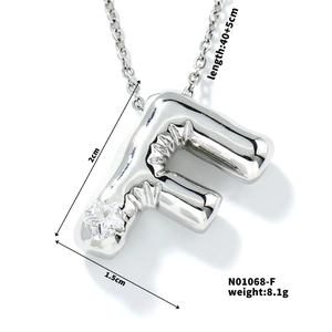 Detailed view of silver balloon initial F pendant with dimensions 2x1.5cm and star zircon