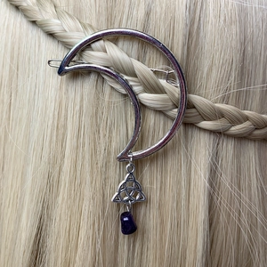 Silver crescent moon hair clip with Celtic knot and purple gemstone on braided hair