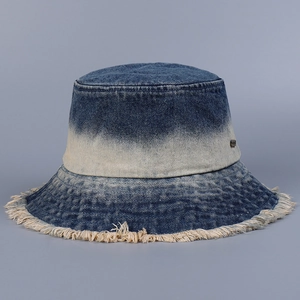 Close-up of the gradient denim bucket hat showing frayed edges and cotton texture