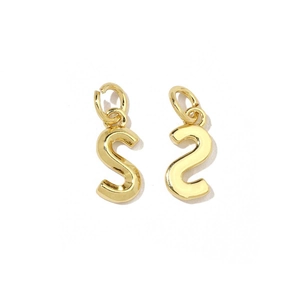 Detailed macro view of a pair of shiny 18K gold letter S charms with polished metal texture