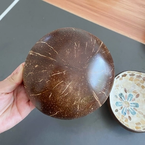 Macro detail of natural coconut shell bowl showing handcrafted brown texture and grain