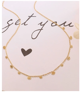Detail view of 18k gold plated choker with hollow eye pendants on fine O-chain links