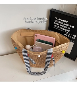 Large straw tote bag interior showing capacity for tablet, umbrella and daily items