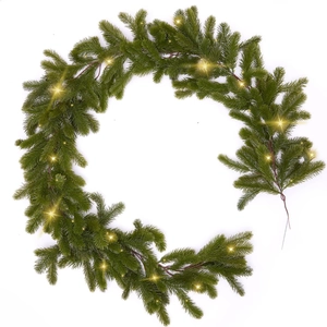 Artificial Christmas garland with green pine needles and warm LED lights for holiday decor
