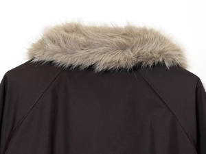 Detail of waterproof parka featuring a detachable faux fur collar and twill texture