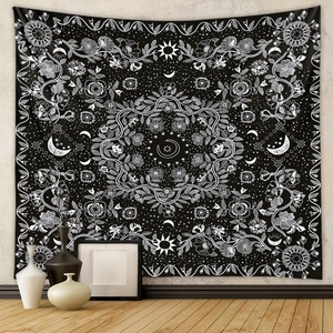 Bohemian mandala tapestry with moon and stars pattern hanging on a minimalist room wall