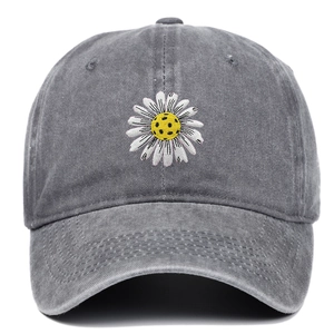 Close-up of small daisy flower embroidery on vintage washed grey denim baseball cap