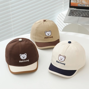 Detailed embroidery of a cartoon bear on color-block cotton baseball caps for toddlers