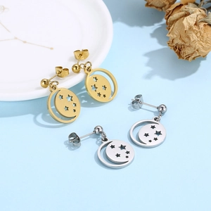 Detailed view of hollow star and moon stud earrings in gold and silver finishes