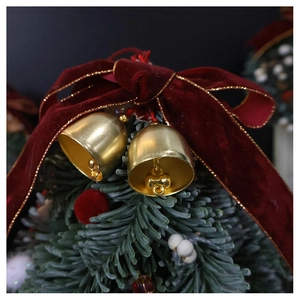 Macro detail of golden bells and burgundy velvet bow on Christmas tree branch