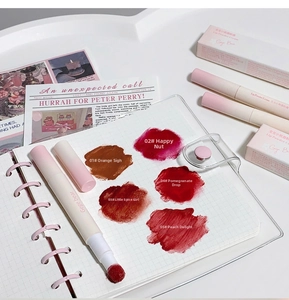 Close-up of five matte lipstick shades on white grid notebook with soft lighting