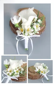 Close-up of white calla lily wedding boutonniere with yellow daisies and silk ribbon