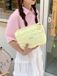 Light yellow heart quilted makeup bag with zipper closure and cute stylish ribbon
