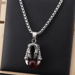 Vintage stainless steel dragon claw necklace featuring a vibrant red bead pendant