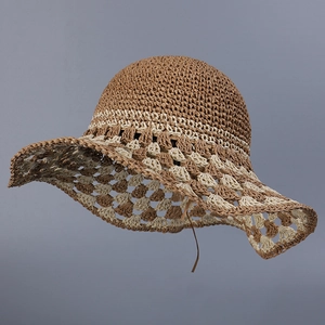 Detailed macro view of handcrafted crochet straw sun hat with two-tone woven texture