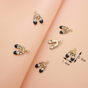 Golden ballet shoe pendant with black enamel and rhinestones, size 1.6cm x 2.5cm