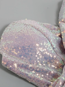 Detailed macro shot showing iridescent sequins and texture of this luxury feather party dress