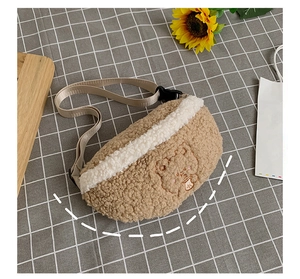 Detail of teddy fleece belt bag with brown and white patchwork and bear embroidery