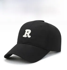 Detail shot of the white towel-embroidered R letter on a black cotton baseball cap