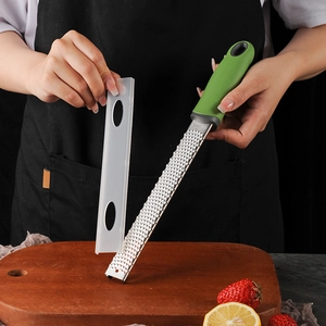 Handheld stainless steel zester with green handle for cheese, citrus and lemon