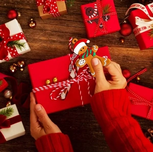 Creative gingerbread man ornament on gift box background for Christmas tree decoration