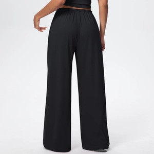 Detail view of high waisted black wide leg trousers with elastic waistband from the back