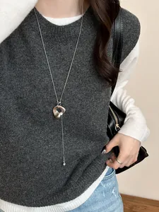Minimalist long sweater necklace with irregular pendant and metal ball charm on model