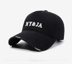 Detail of vintage black baseball cap showing 3D NY&JA embroidery and distressed brim