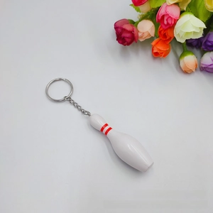 Mini bowling pin keychain with red stripes and metal chain on a white background