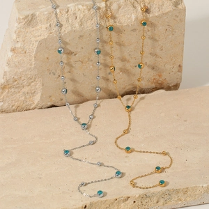 Double-sided Evil Eye long necklace in gold and silver finish with blue beads