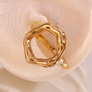 Detailed macro view of an irregular 18K gold plated ring with organic lava texture