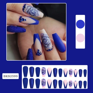 Detail of long ballerina press-on nails with blue rose patterns and rhinestone accents