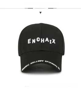 Close-up of white 3D letter embroidery and brim stitching on a black cotton baseball cap