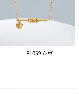 Detailed macro view of a gold-plated necklace featuring a knot pendant and metal ball charm