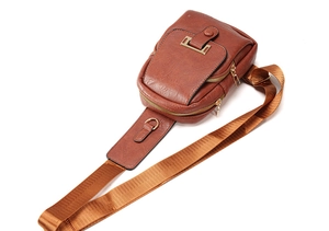 Macro shot of brown PU leather texture and durable metal zipper on a retro backpack