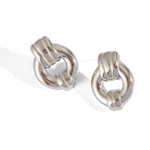 Close-up of silver knot stud earrings in polished waterproof titanium steel finish