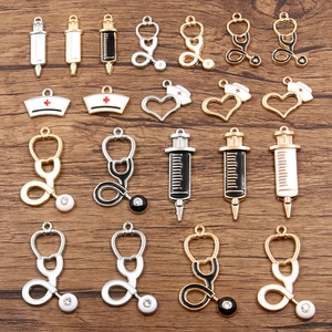 Assorted medical charms like stethoscopes and syringes on wood background for DIY jewelry