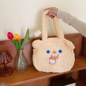 Detail of soft lamb-like plush handbag with cute animal embroidery and sturdy top handles