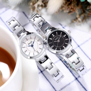 Fashionable women's quartz watches with steel bands and diamond accents on a plaid surface