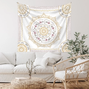 Close-up of bohemian mandala tapestry featuring pink floral patterns on living room wall