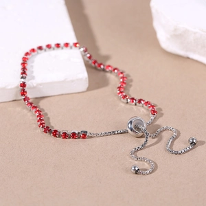 Detailed shot of adjustable silver bracelet with red square cubic zirconia stones