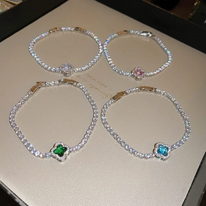 Detail of four-leaf clover tennis bracelets with zircon inlay in multi-colored stones