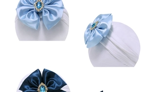 Detail of baby nylon headband featuring satin bow with rhinestone and blue gemstone
