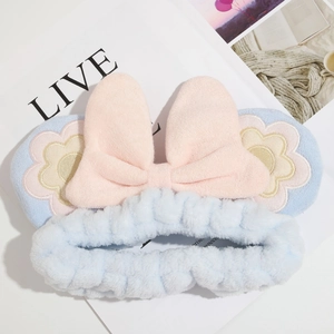 Soft plush floral embroidery headband with large pink bow for face washing and skincare