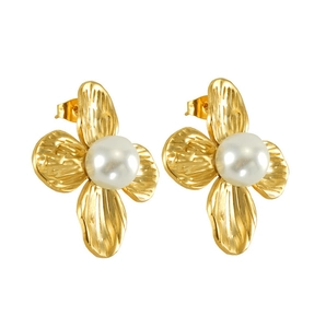 Detailed macro view of vintage gold flower petal earrings featuring white center pearls