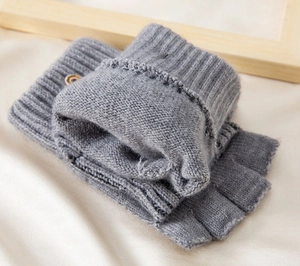 Detail of grey knitted fingerless gloves with sheep wool lining and retro wooden button