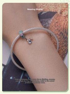 Detailed view of S925 silver bracelet featuring blue enamel heart beads and rabbit pendant